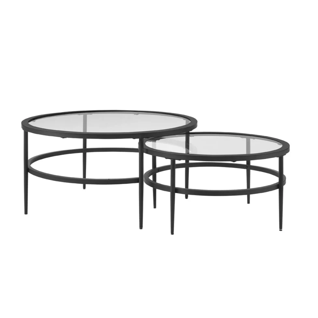 Set of two round glass tables with black metal frames on a white background