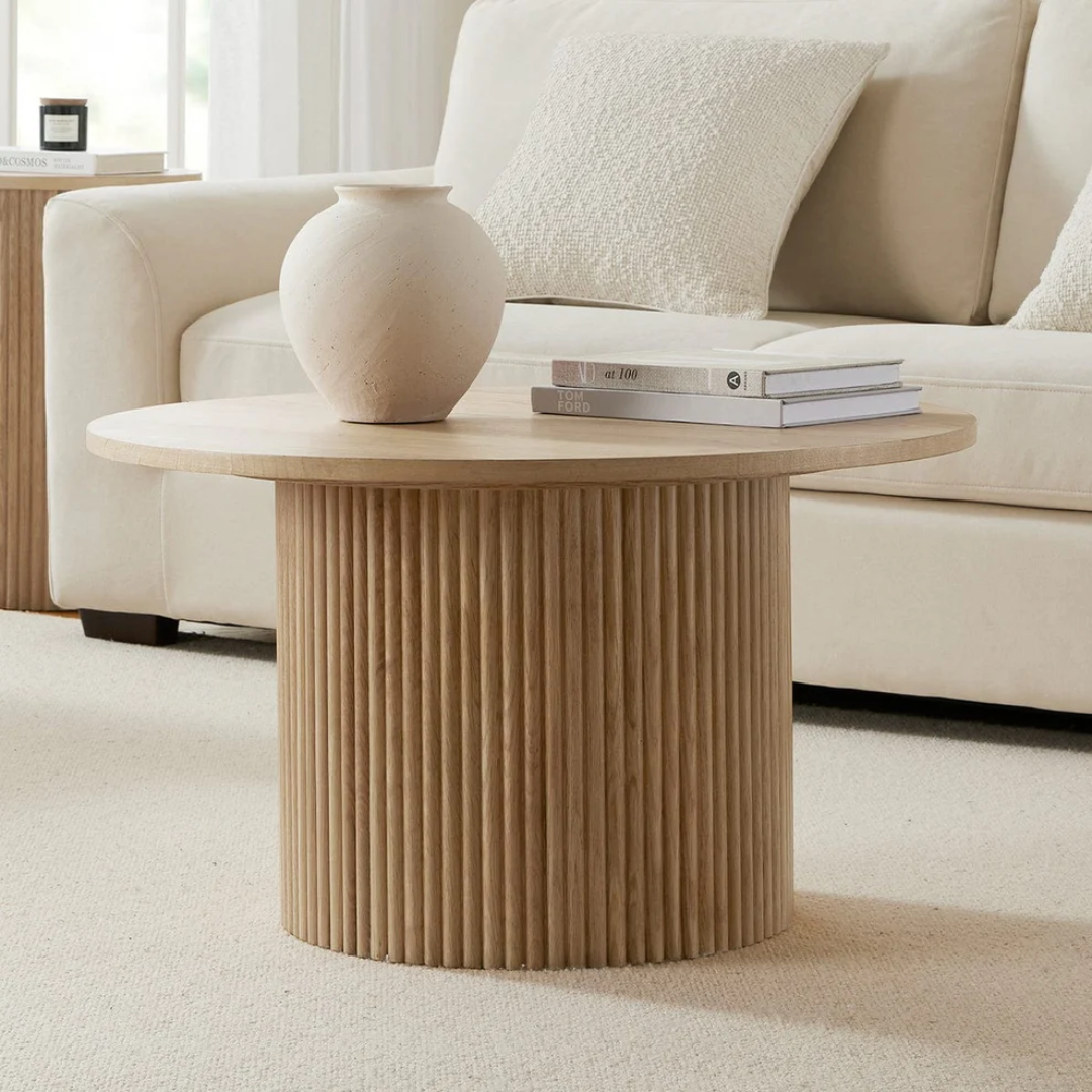 Wooden side table with a textured base in a living room setting
