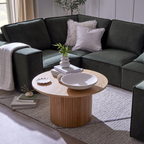 Modern living room with a dark gray sectional sofa and wooden coffee table.