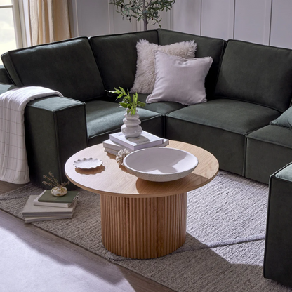 Modern living room with a dark gray sectional sofa and wooden coffee table.