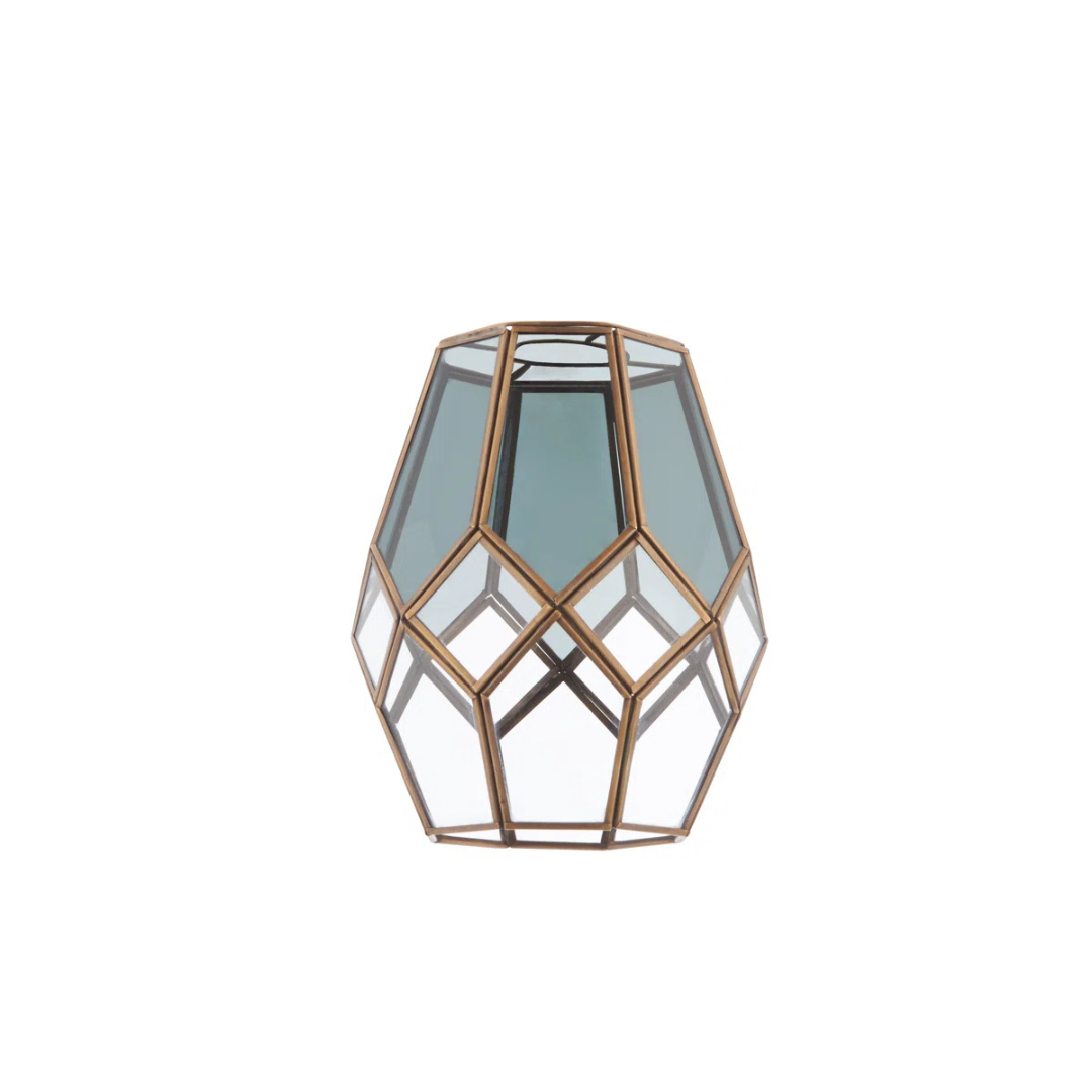 Geometric glass lantern with bronze frame on a white background