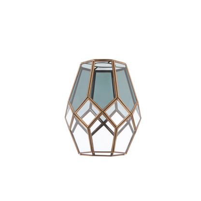 Geometric glass lantern with bronze frame on a white background