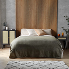 Rattan Black Cabinet Sideboard, set next to a bed in a modern bedroom.