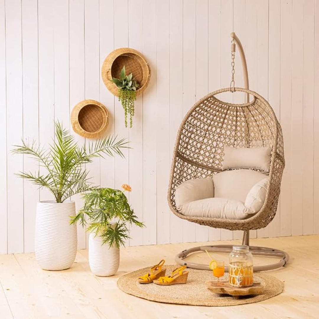 Rattan Hanging Egg Chair And Stand, set in a light toned home.