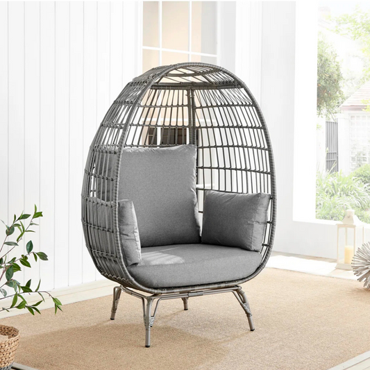 Rattan Standing Egg Chair, in a modern home, angled view.