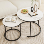 Two marble coffee tables with black metal legs in a living room setting.