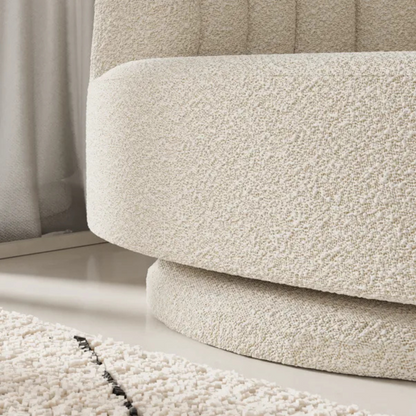 scalloped bouclé swivel chair with fluted backrest design, close up to base of the chair.