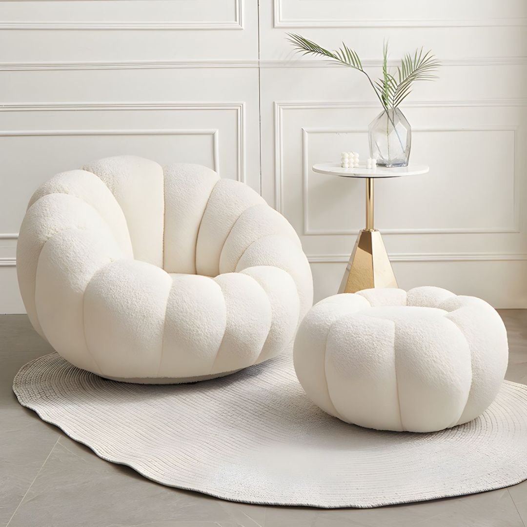 white scalloped pumpkin chair and ottoman, on a patterned rug in a modern home.