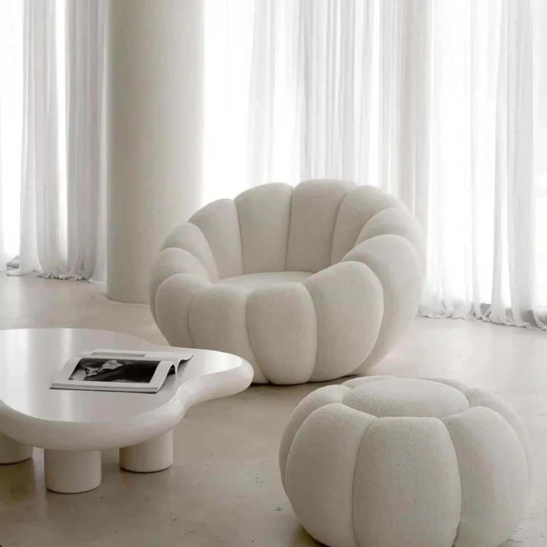 white scalloped pumpkin chair and ottoman, set up in a modern living room.