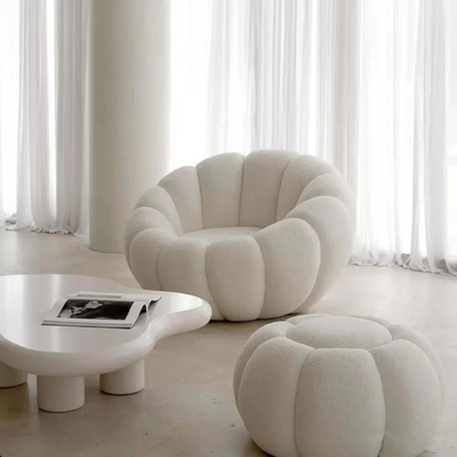white scalloped pumpkin chair and ottoman, set up in a modern living room.