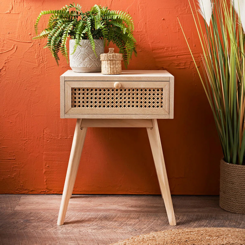 Single Drawer Bedside Table Rattan, with a mid century orange background.