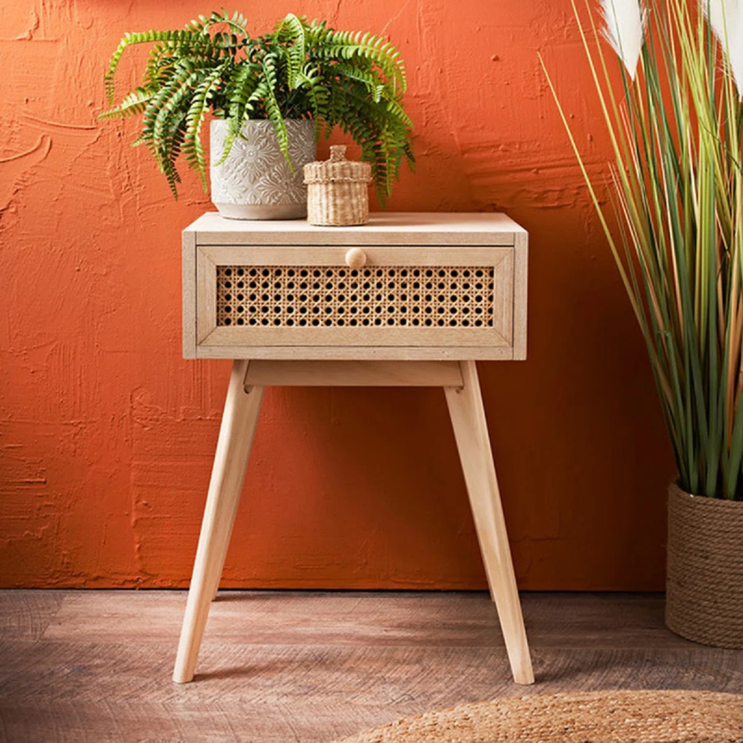 Single Drawer Bedside Table Rattan, with a mid century orange background.