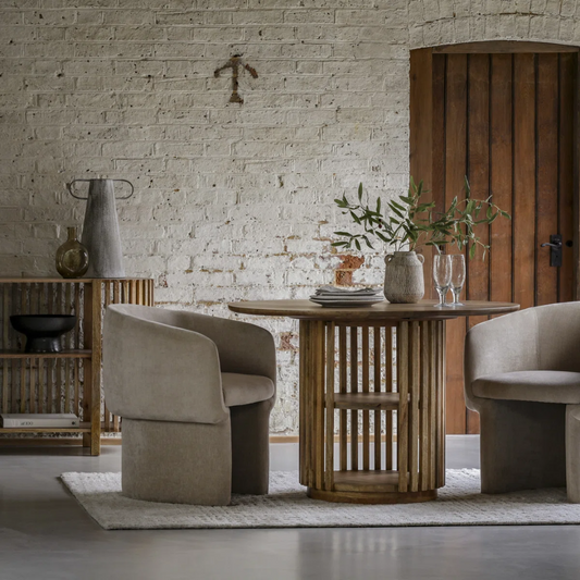 Dining area with wooden table and chairs in a rustic setting