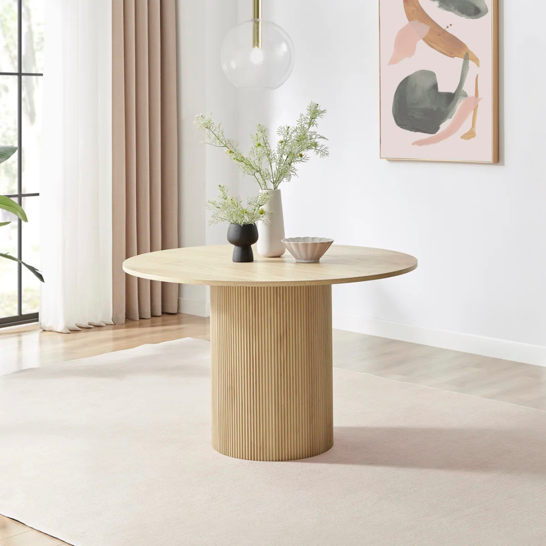 Slatted Round Contemporary Dining Room Table, set in a modern model home with ornaments.