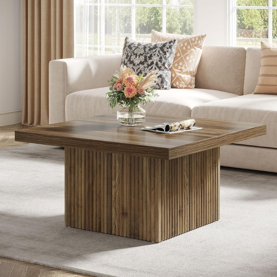 Wooden coffee table in a living room with a beige sofa and decorative pillows.