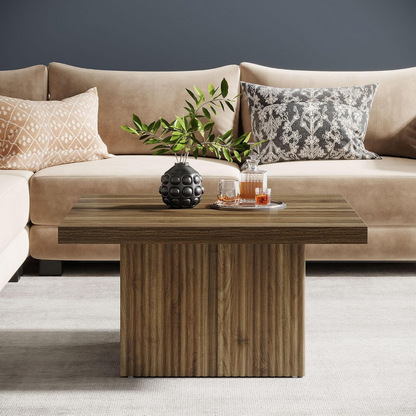 Beige sofa with decorative pillows and a wooden coffee table in a living room setting.