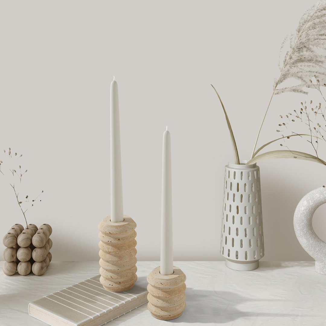 Ceramic candle holders and vases on a neutral background