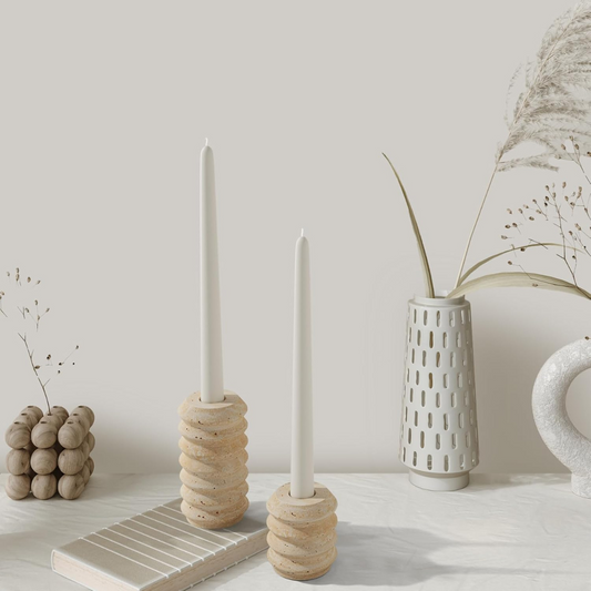 Ceramic candle holders and vases on a neutral background