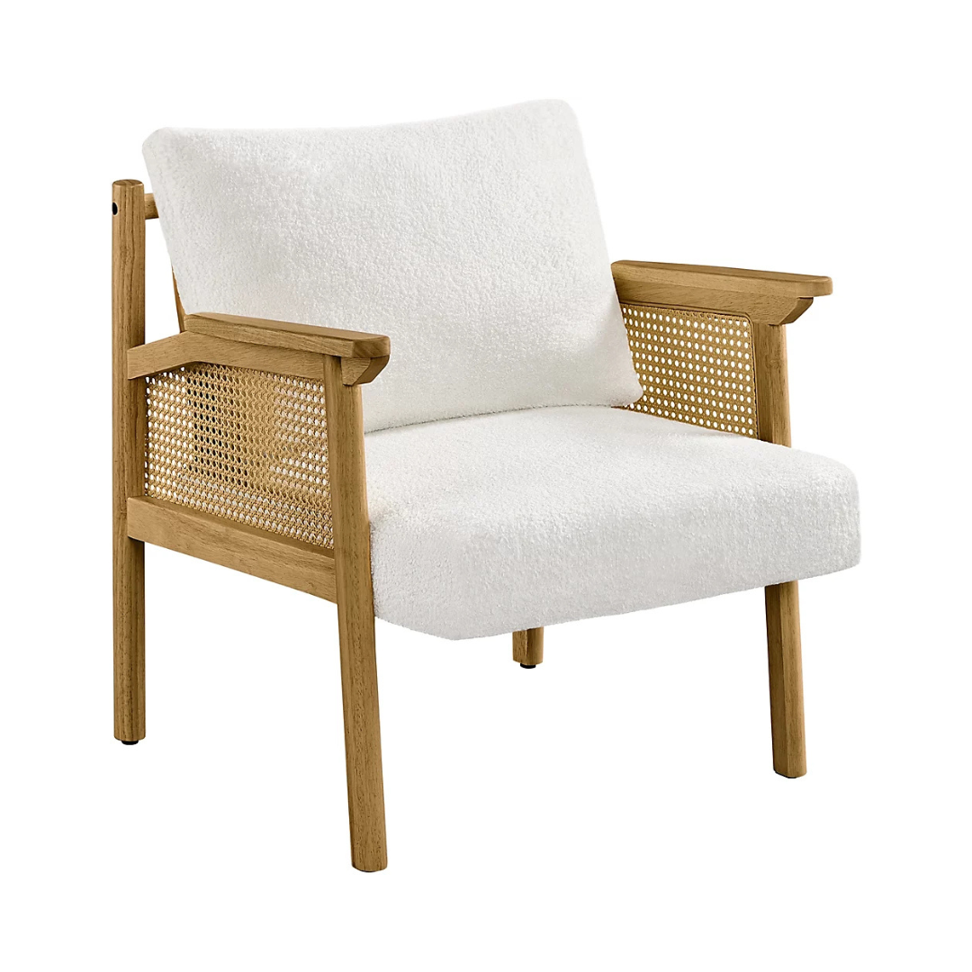 upholstered indoor rattan armchair with wood frame, white background, angled view.