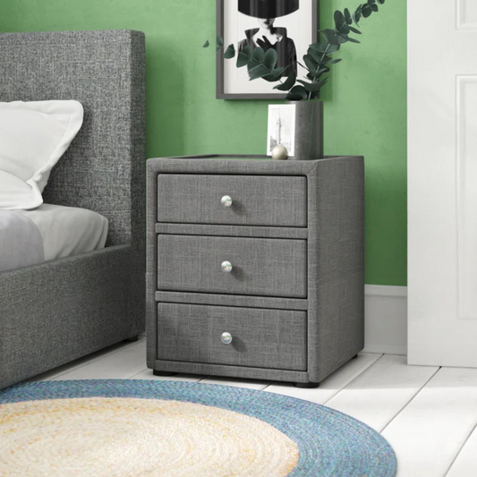 Upholstered Modern Grey Bedside Cabinet, set in a model home.