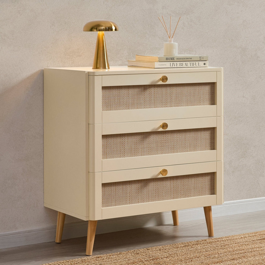 Beige side table with wicker drawers and decorative items on a neutral background