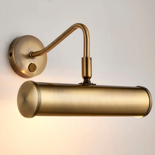 Brass wall-mounted light fixture on a neutral background