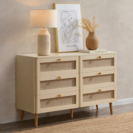 Beige sideboard with decorative items against a beige wall