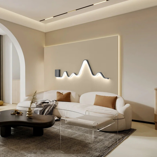 Modern living room with a white sofa, coffee table, and decorative wall light fixture.