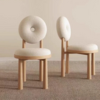 white boucle dining chair with circular back and soft seat, front and side view in a home setting.