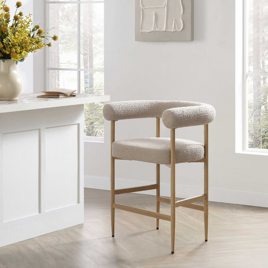 Beige bar stool in a bright room with a white desk and window.