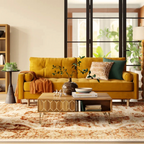 Wooden art deco coffee table with gold accents, set in front of a yellow sofa, in a mid century home.