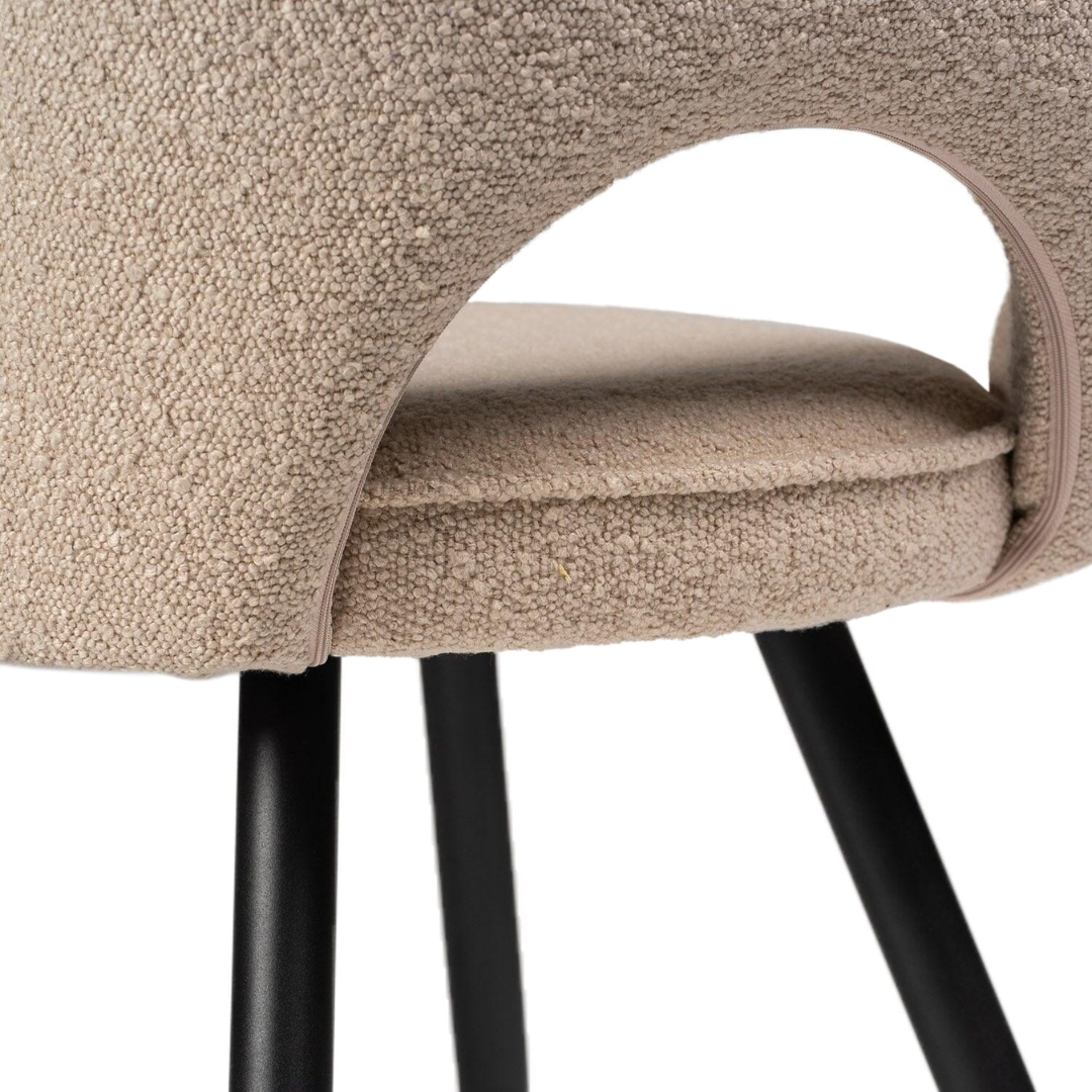 Beige Boucle Dining Room Chairs close up of the black legs