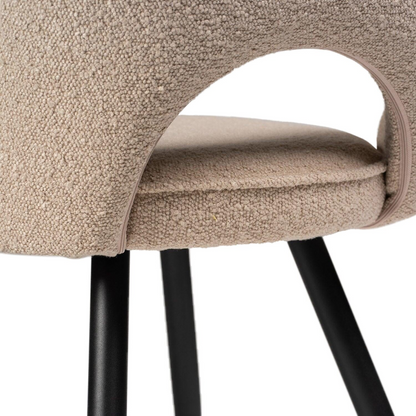 Beige Boucle Dining Room Chairs close up of the black legs